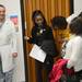 University of Michigan Dr. Massimo Arcerito, M.D. and Cass Tech freshman Ajene Hines crack up as fellow students Talandra Royal, Naomi Nichols and Kala Coston look during a tour of the Clinical Simulation Center at University of Michigan Hospital on Thursday, Jan. 10. Melanie Maxwell I AnnArbor.com